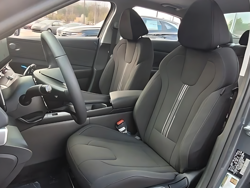 Interior front seats and cockpit of a modern Hyundai showcasing premium materials and technology